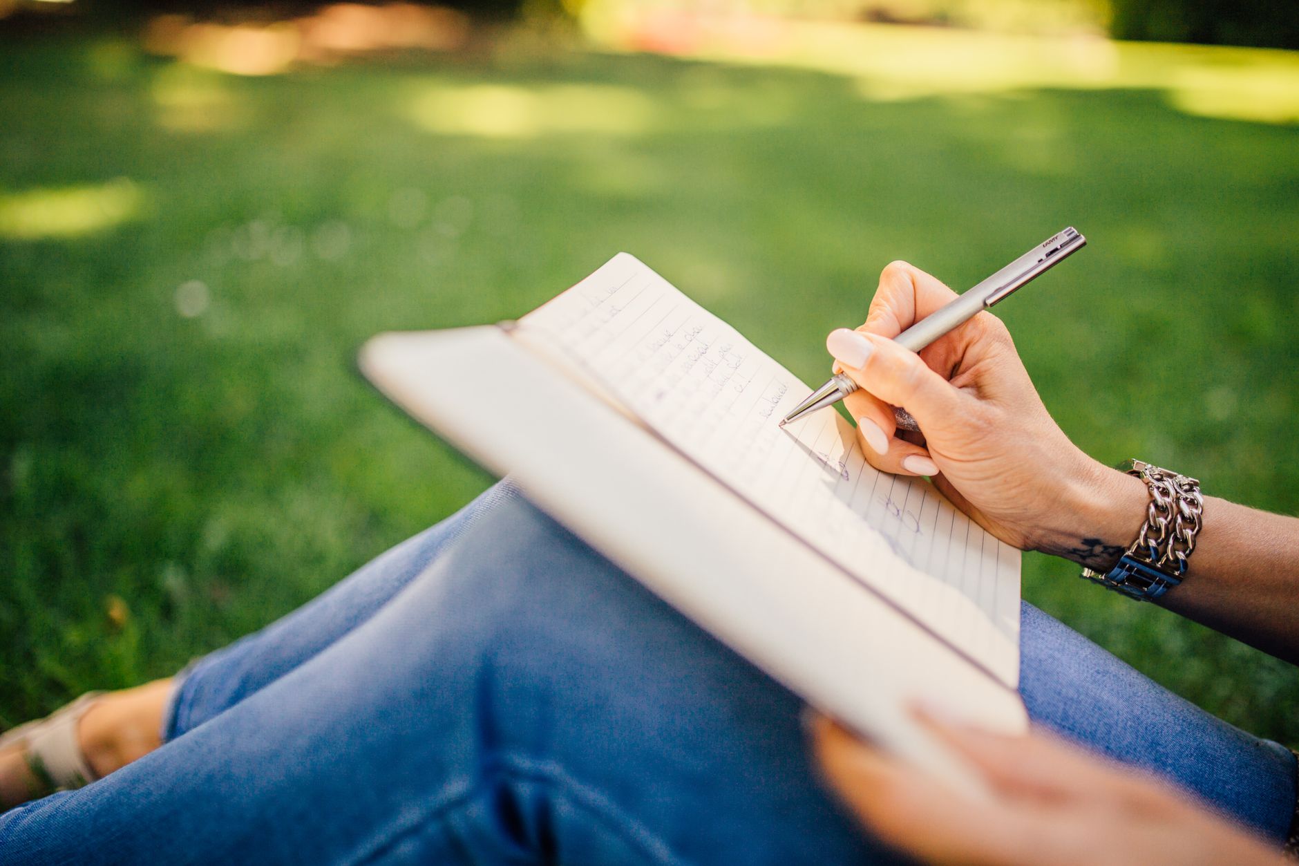 Travel journal editor taking notes in serene surroundings